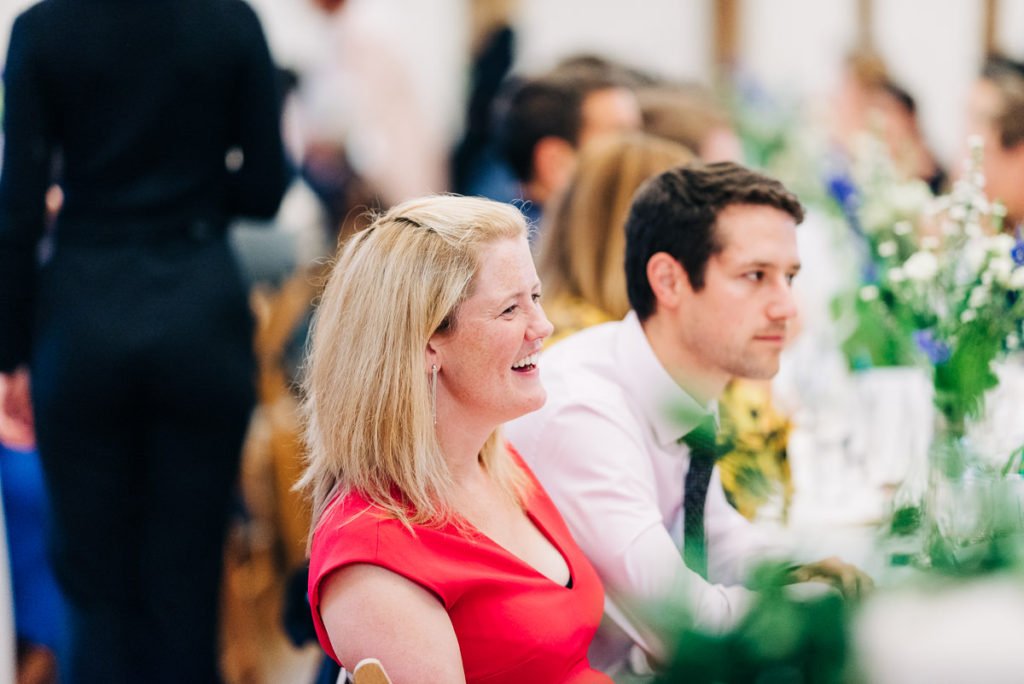 Guests laughing at wedding speeches