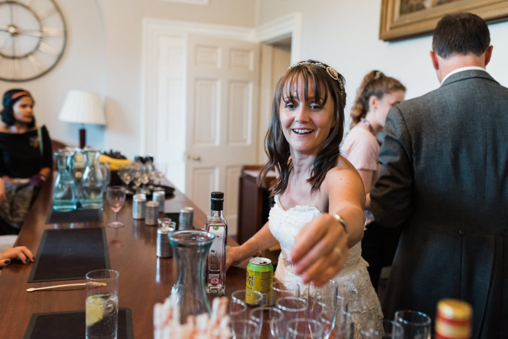 Bride serves the drinks from the gin bar