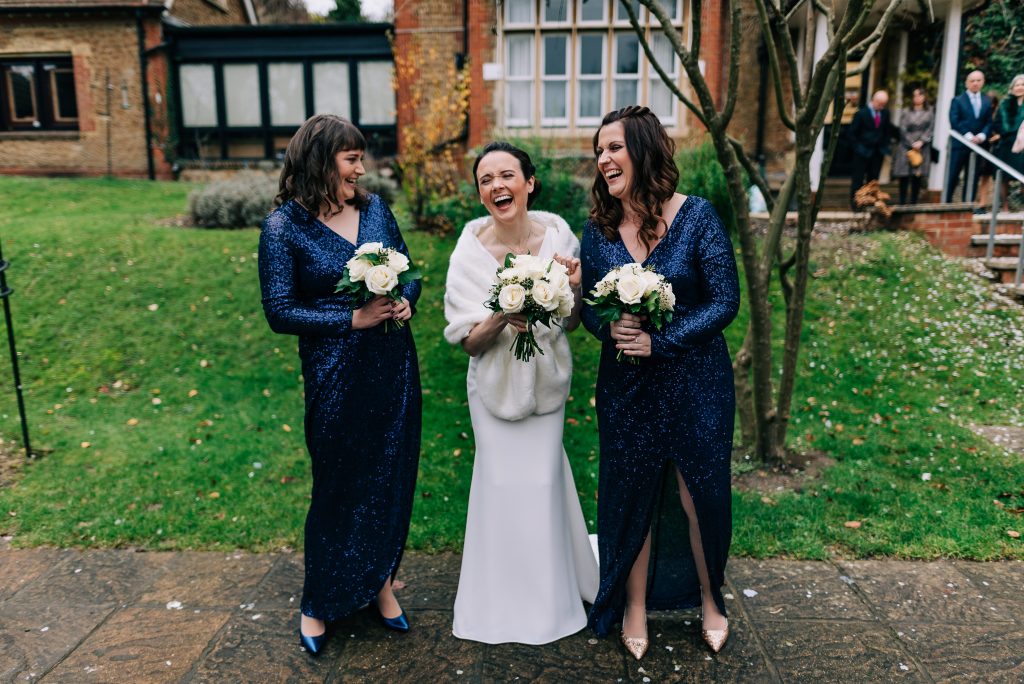 Bride laughs with bridesmaids