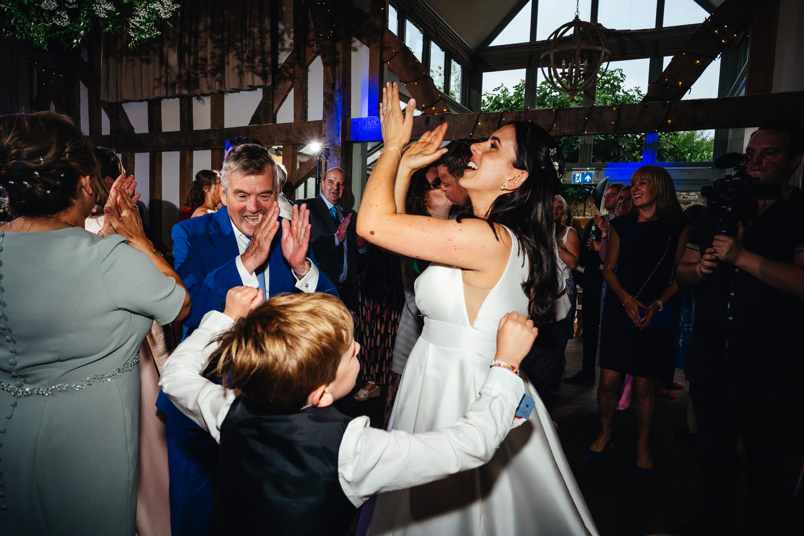 Second wedding photographer capturing different angles on the dancefloor
