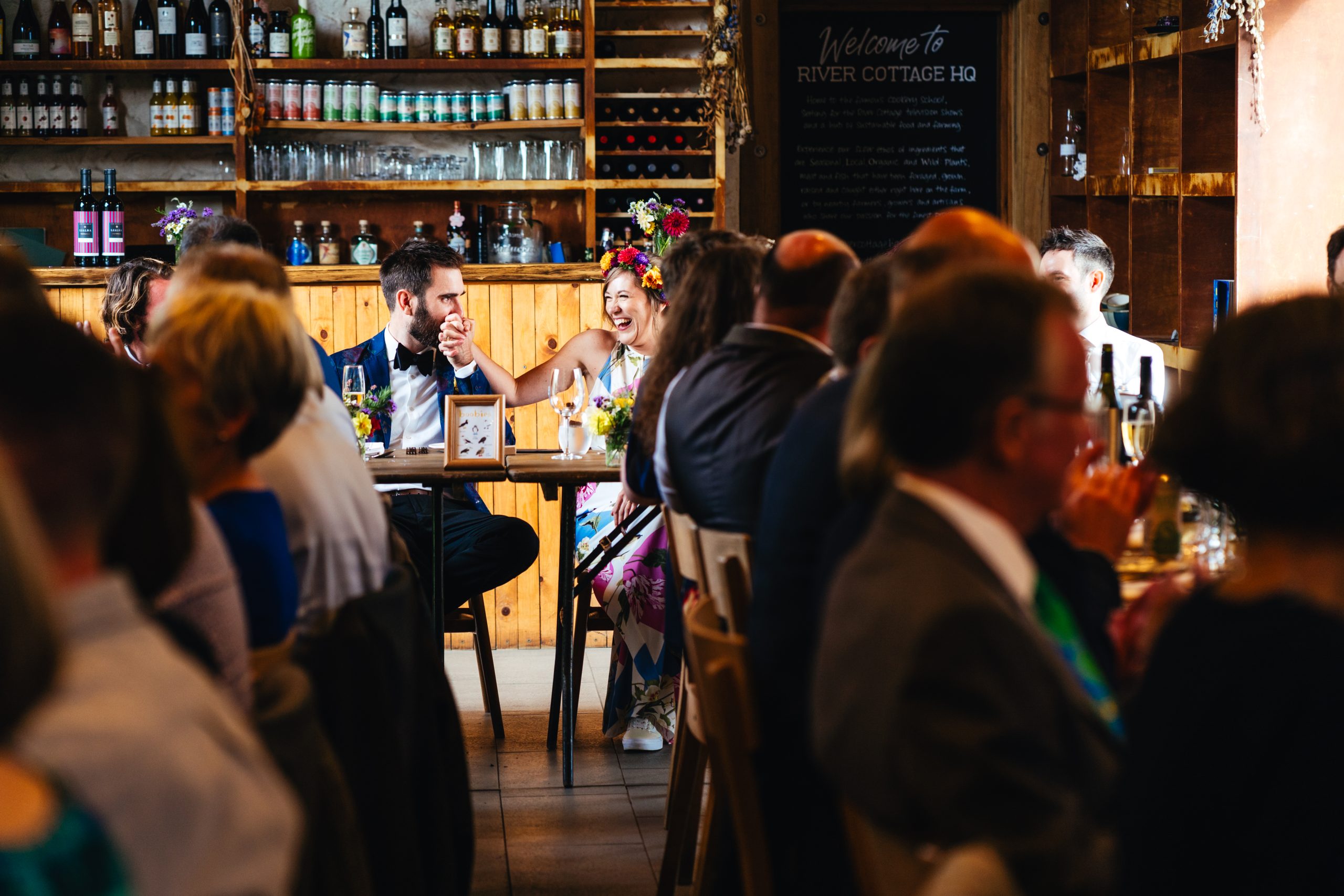Bride and groom enjoy dinner at their Riverford Cottage wedding