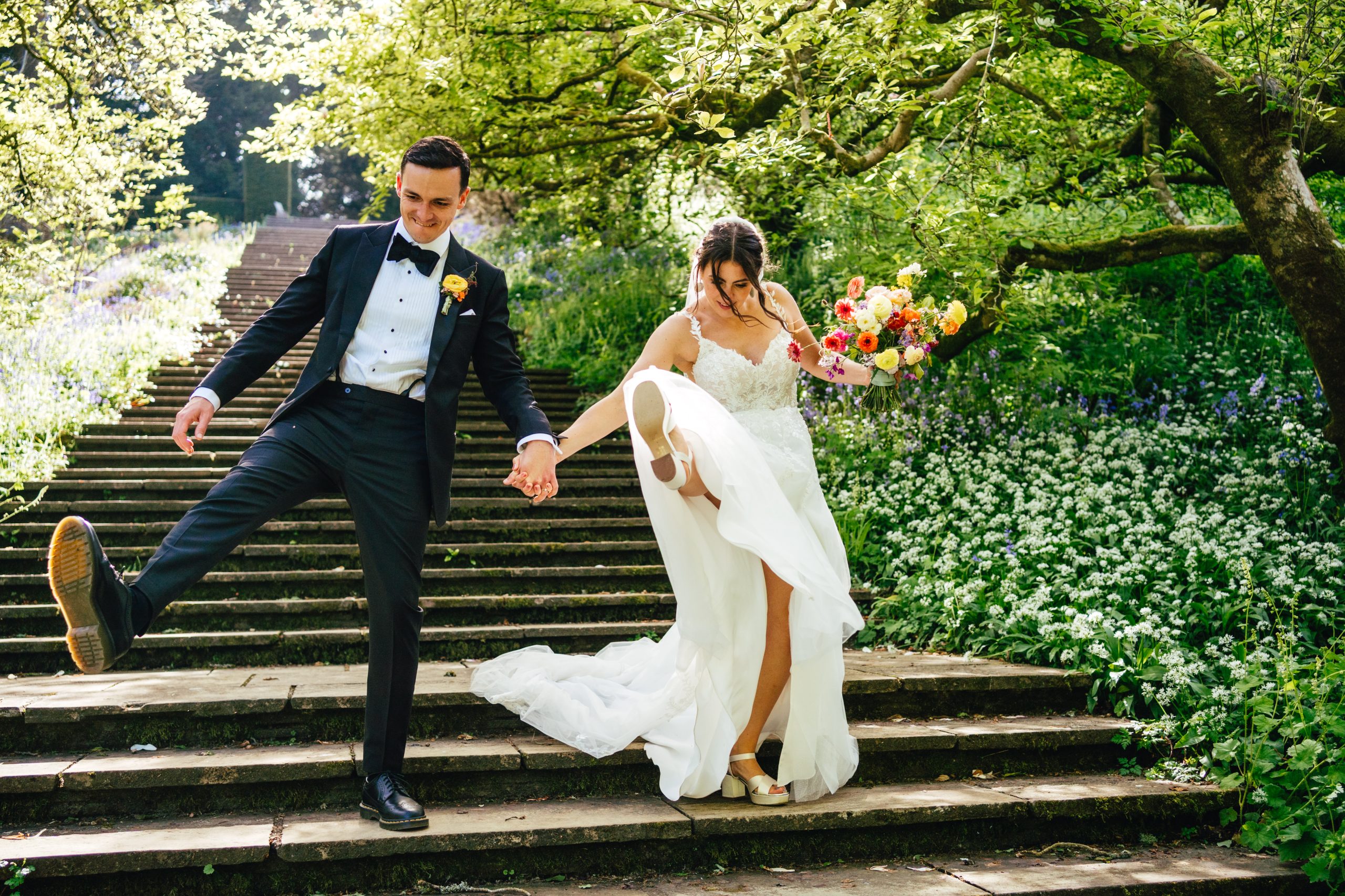 Couple having fun portraits on their wedding day at Dartington Hall